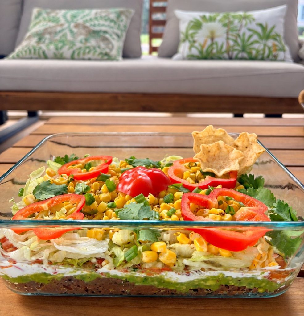 Vegan 7-layer dip with black beans, guacamole, pico de gallo, lettuce, corn and red pepper for Sukkot